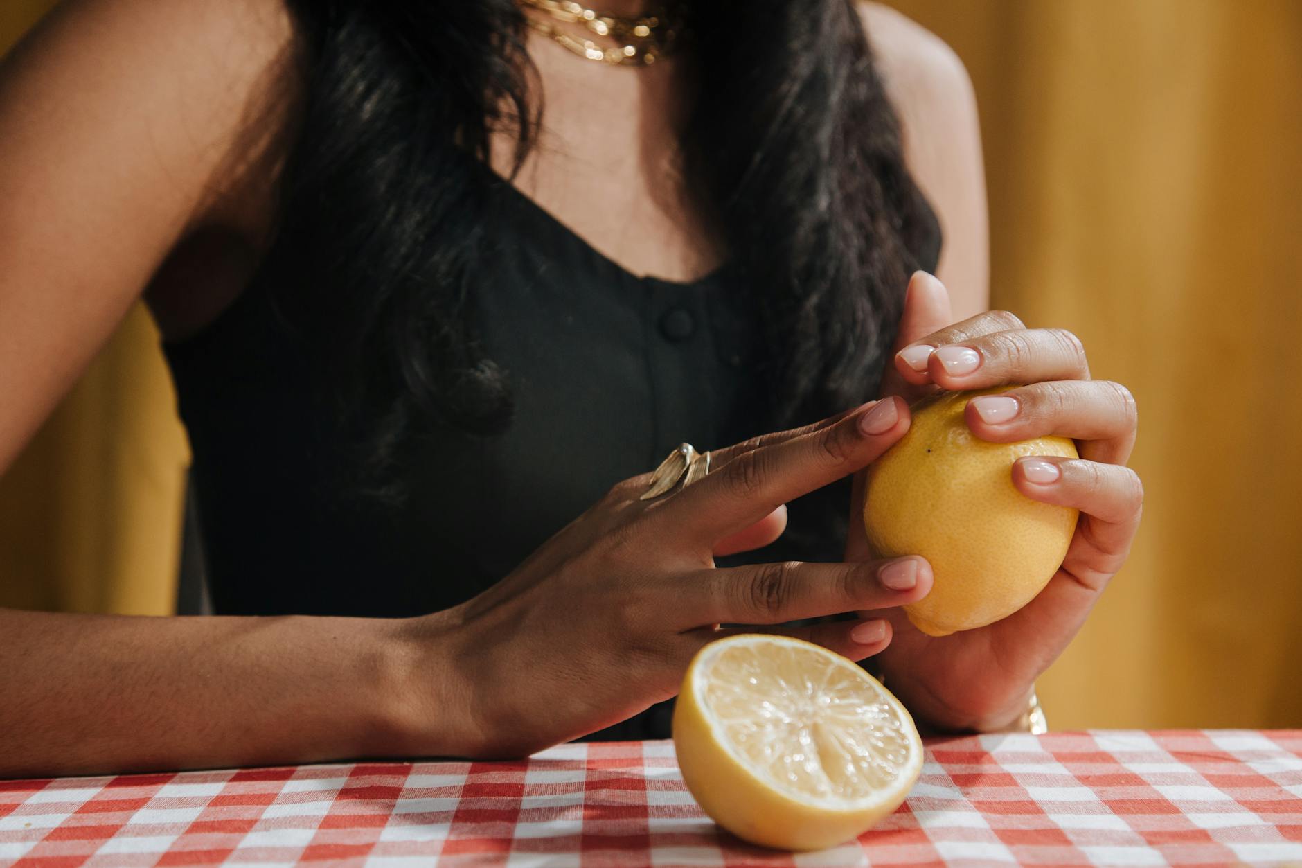 Intimate close-up of hands holding a sleek blue vibrator against a purple background, representing gentle reconnection to pleasure