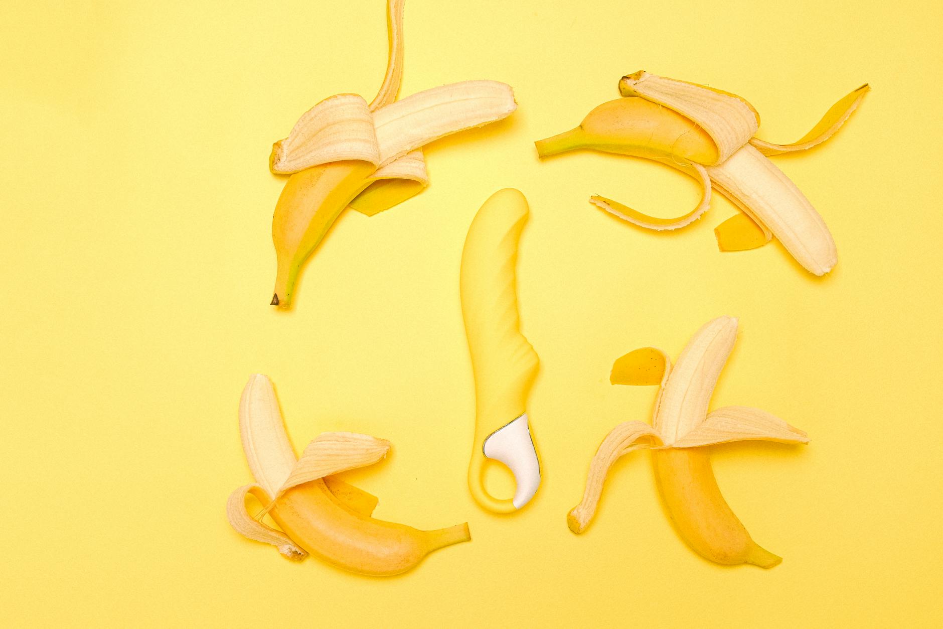 A yellow lemon clitoral vibrator on a bright yellow background surrounded by fresh lemons, symbolizing refreshed desire and reclaimed pleasure.