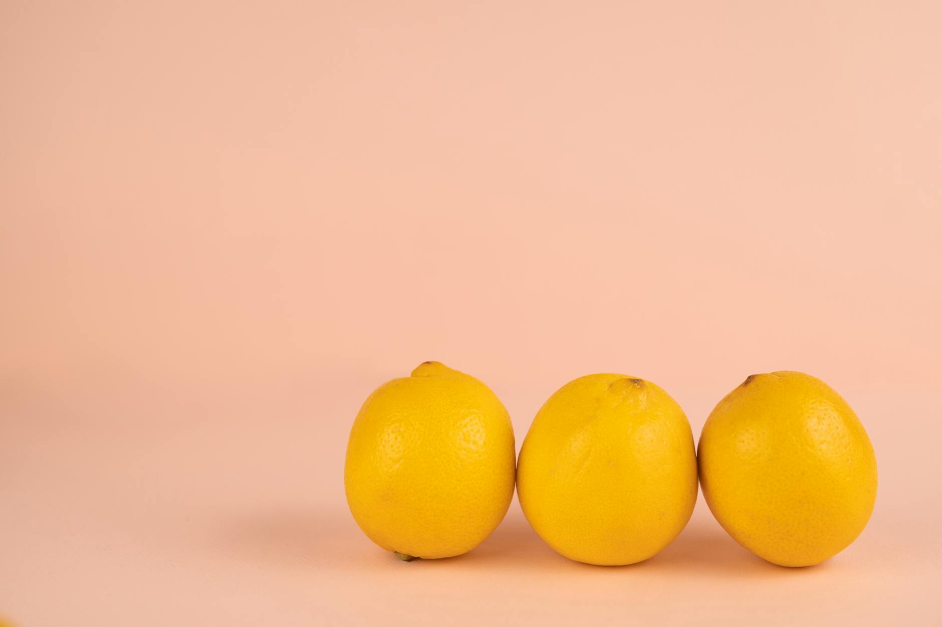 Bright ripe lemons on a pastel background, symbolizing renewed sensation and freshness